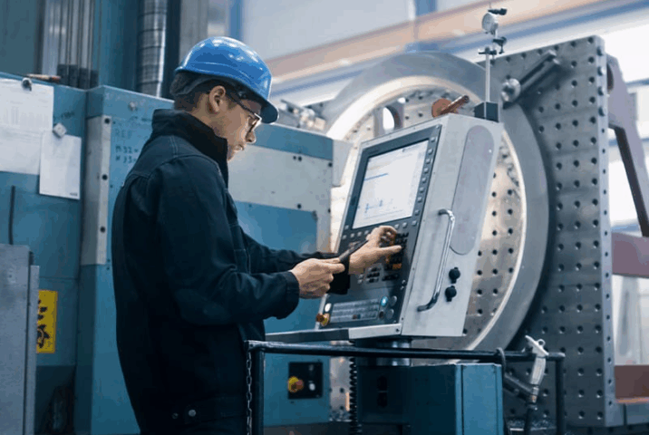 Plant Supervisor inputs information into a TAA Compliant monitor in a factory